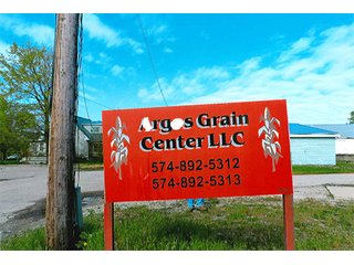 <b>TRACT #1 - GRAIN ELEVATOR</b>  (<b>SOLD - 9/9/16 $110,000</b>)
Note:  The grain bins, drier and legs are on R.R. leased property.  Mr. Voreis stated that lease payment is $900/year.

<b>Improvements - Grain Bins, Drier & Legs:</b>
1994     90,000 bu. bin with air tubes
1994     15,000 bu. hopper bin
               7,000 bu. bin
             42,000 bu. bin with air tube
<b>Drier:</b>  12'x45';1994 Zimmerman grain drier; S.S. 1,500 bu./hr. at 10 pts.;Natural gas
<b>Leg:</b>  1994 110' grain leg; 8,000 bu./hr.
<b>Drier Grain Leg:</b>  5,000 bu./hr.
<b>North Leg:</b>  7,000 bu./hr.
<b>Top Conveyor:</b>  1994 Chain Conveyor
<b>Bottom Conveyor:</b>  U-Trough Auger
<b>Dump Pit:</b>  Approx. 150 bu. with auger to leg

<b>Office:  Portable</b>  A 10' x 50' office with 2 separate offices, customer counter area, 1 restroom

<b>Grain Probe:</b>  A Hyd. Grain Probe

<b>Scales:</b>  10' x 60' Metal deck, scales, load cells, 100,000 lb. capacity, digital read-out and printer

<b>Quonset:</b>  A 41' x 120' metal Quonset building with concrete floor, top auger with 70,000 bu. capacity.

<b>Shop:</b>  A 22' x 40' wood frame with metal siding, concrete floor, heater

<b>Rail Siding:</b>  7+ Car rail siding along the east side of the grain bins.

<b>Utilities:</b>  City - Water and sewer; Electric - 480 (4) phase; Gas - Nipsco 

<FONT FACE="Arial, Helvetica, sans-serif" size="2" color="#0000FF"><b>TRACT #2 - STORAGE WAREHOUSE</b> (<b>STILL AVAILABLE</b>)

<b>2 Lots, Improvements</b>  60' x 112' wood frame structure, concrete floors, 4 doors, dock high load-out.</font face>



 - Grain Elevator (SOLD - 9/9/16) Storage Warehouse Still Available